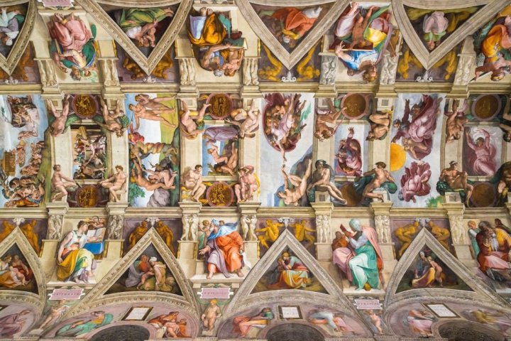 a bunch of stuffed animals on display with Sistine Chapel in the background